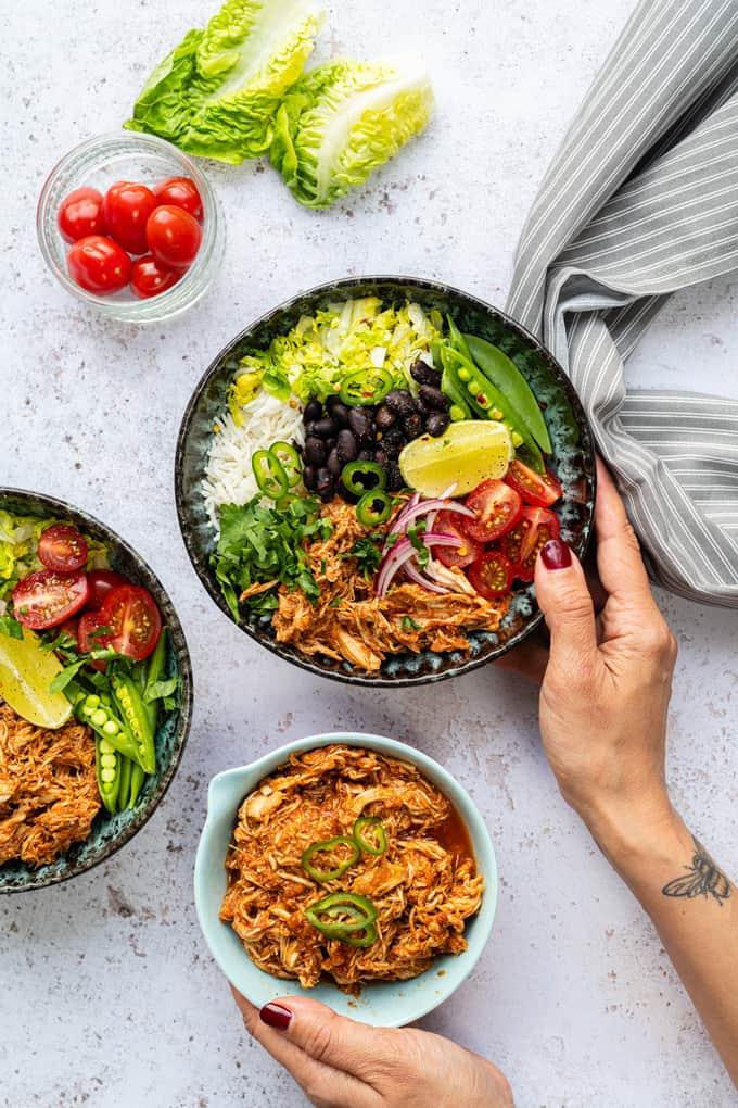Bowl of Diet Coke Chicken served with rice black beans and salad