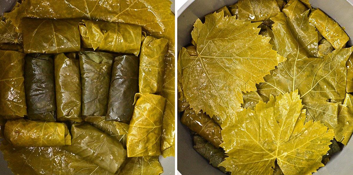 A close-up of grape leaves stuffed with rice, tightly rolled and arranged in a pot. On the right, loose grape leaves cover the top, ready for cooking. The leaves are shiny and greenish-yellow.