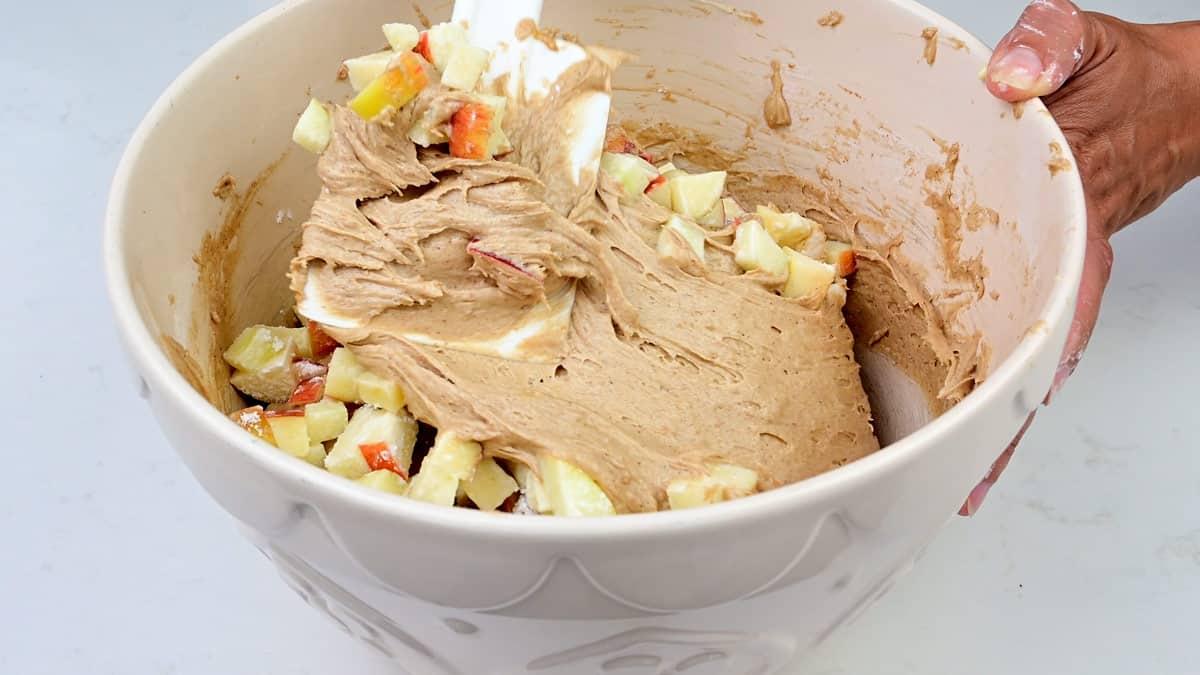 Folding apple chunks into Doset apple cake batter