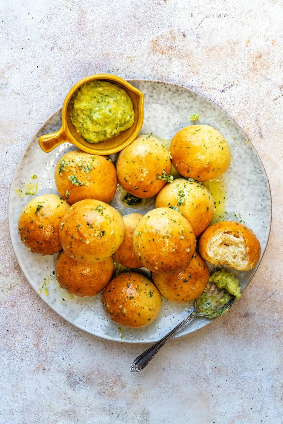 Plate with garlic dough balls and dip on the side