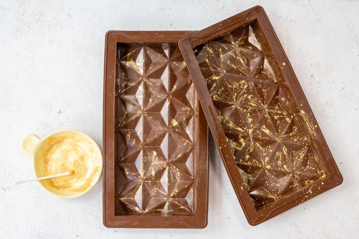 two chocolate bar molds, decorated with luster powder