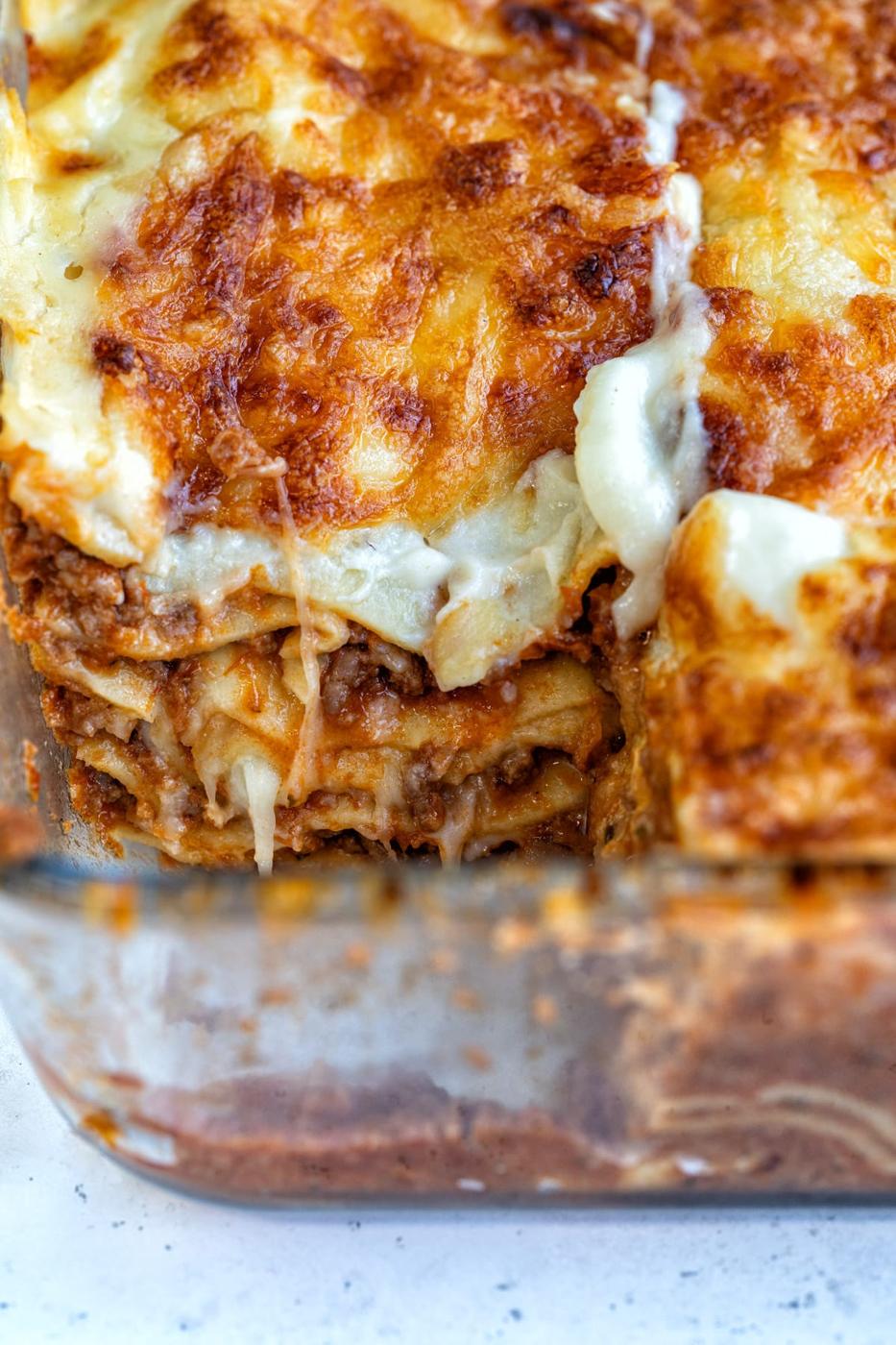 close up on lasgana dish with one slice taken out