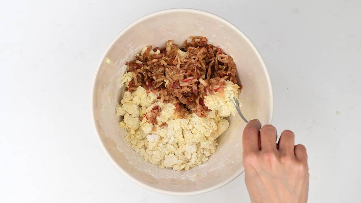 mixing grated apple into scone dough