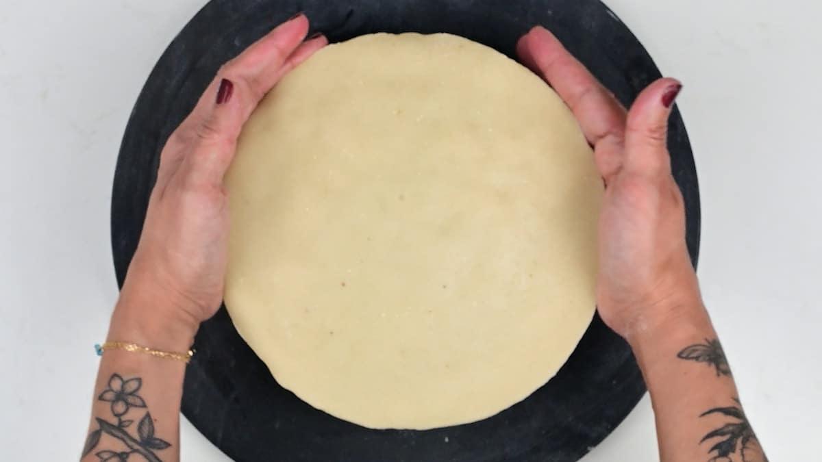 topping Christmas cake with a layer of marzipan