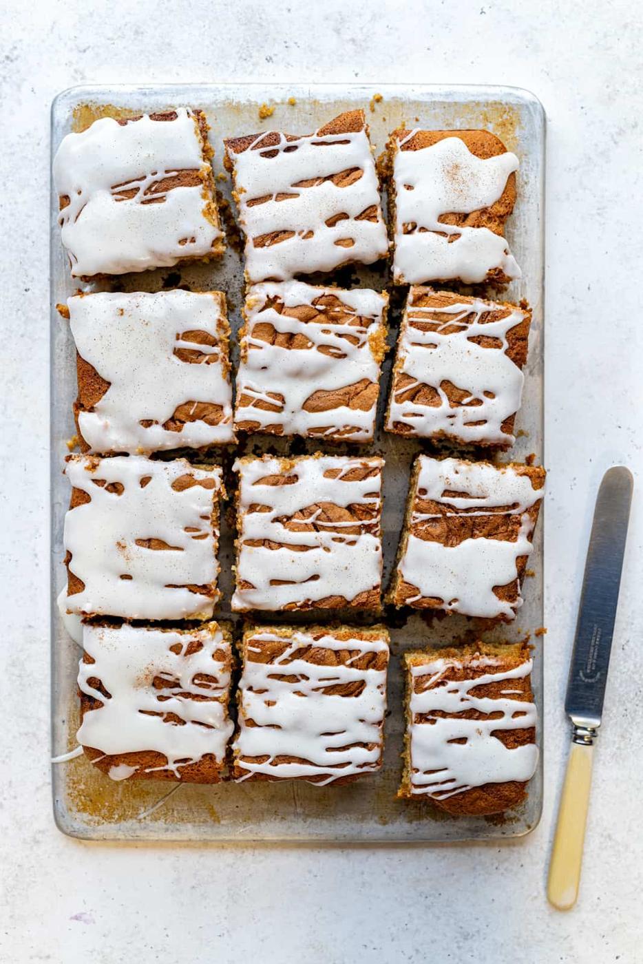 overhead view of sliced cinnamon sheet cake