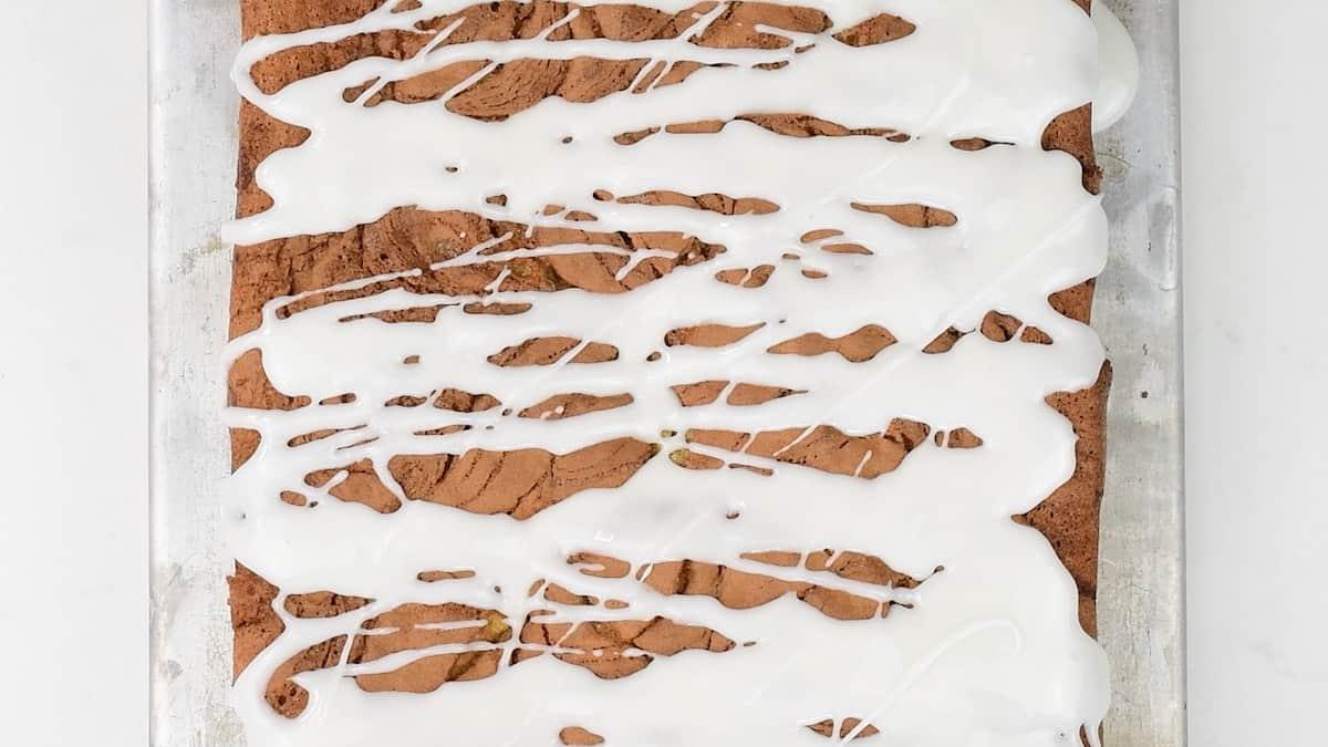 drizzling cinnamon sheet cake with simple glaze