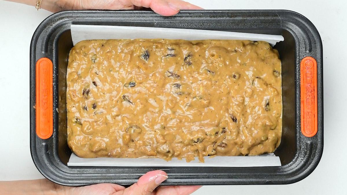 fruit loaf batter in a lined loaf tin