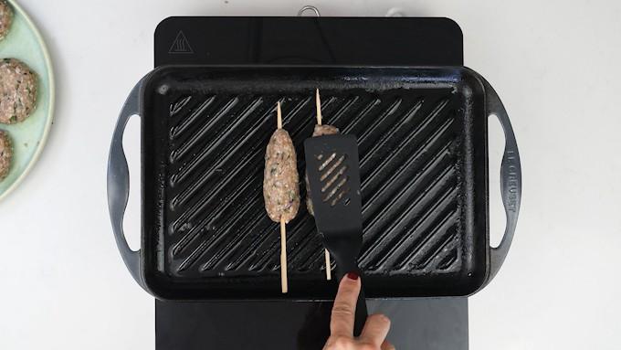 Cooking kofta on a griddle pan