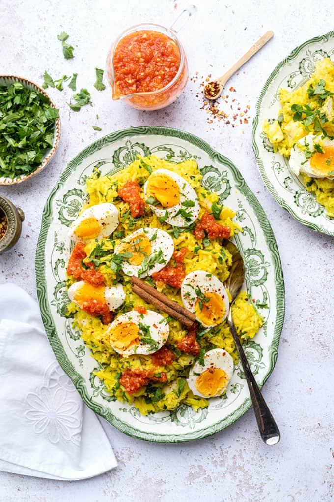 Kedgeree with smoked haddock and boiled eggs served in a platter with curried tomato sauce