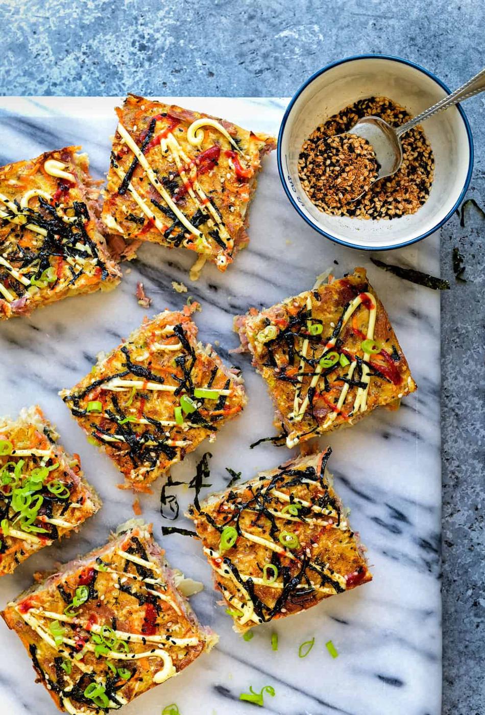 savory pancake cut into squares on a marble board