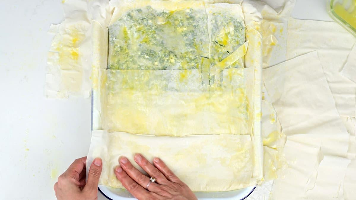 Covering spinach pie with filo