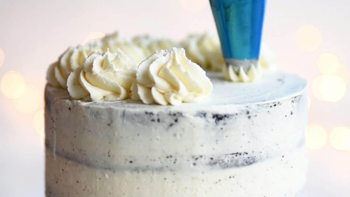 Piping whipped cream over Black Forest Gateau