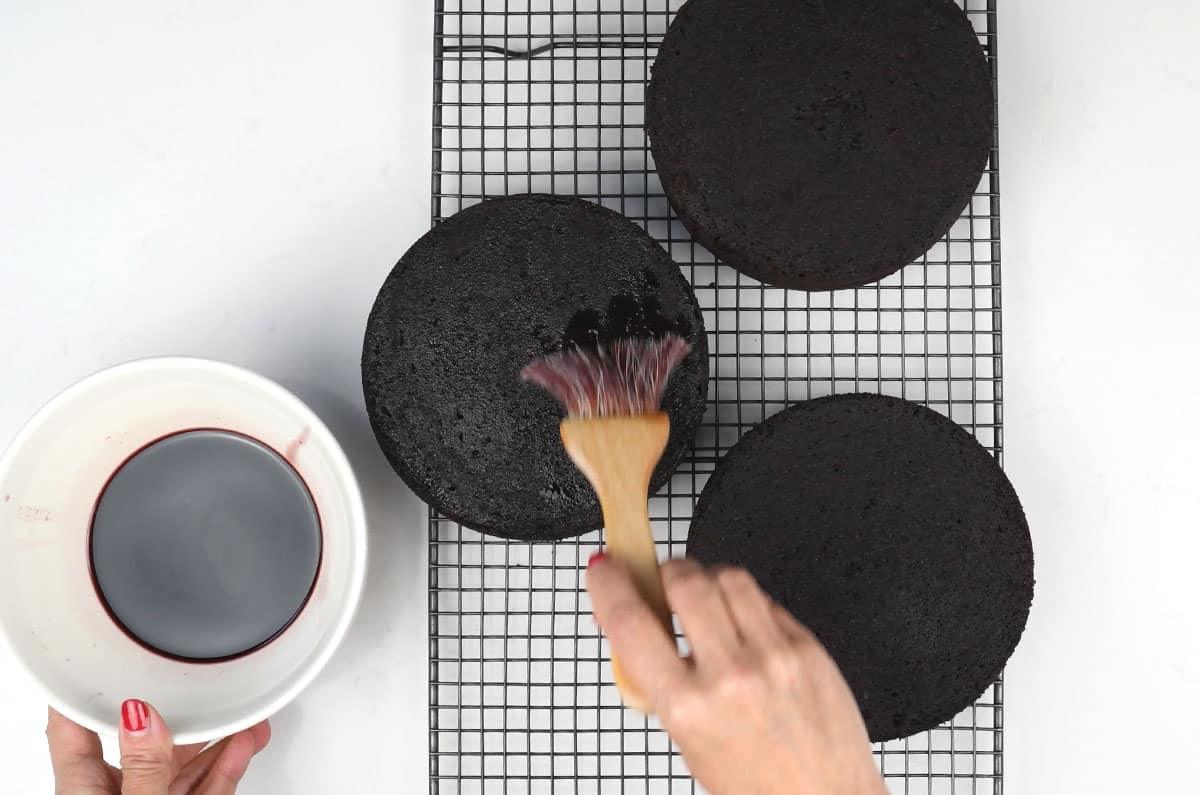 Brushing chocolate cake with Kirsch