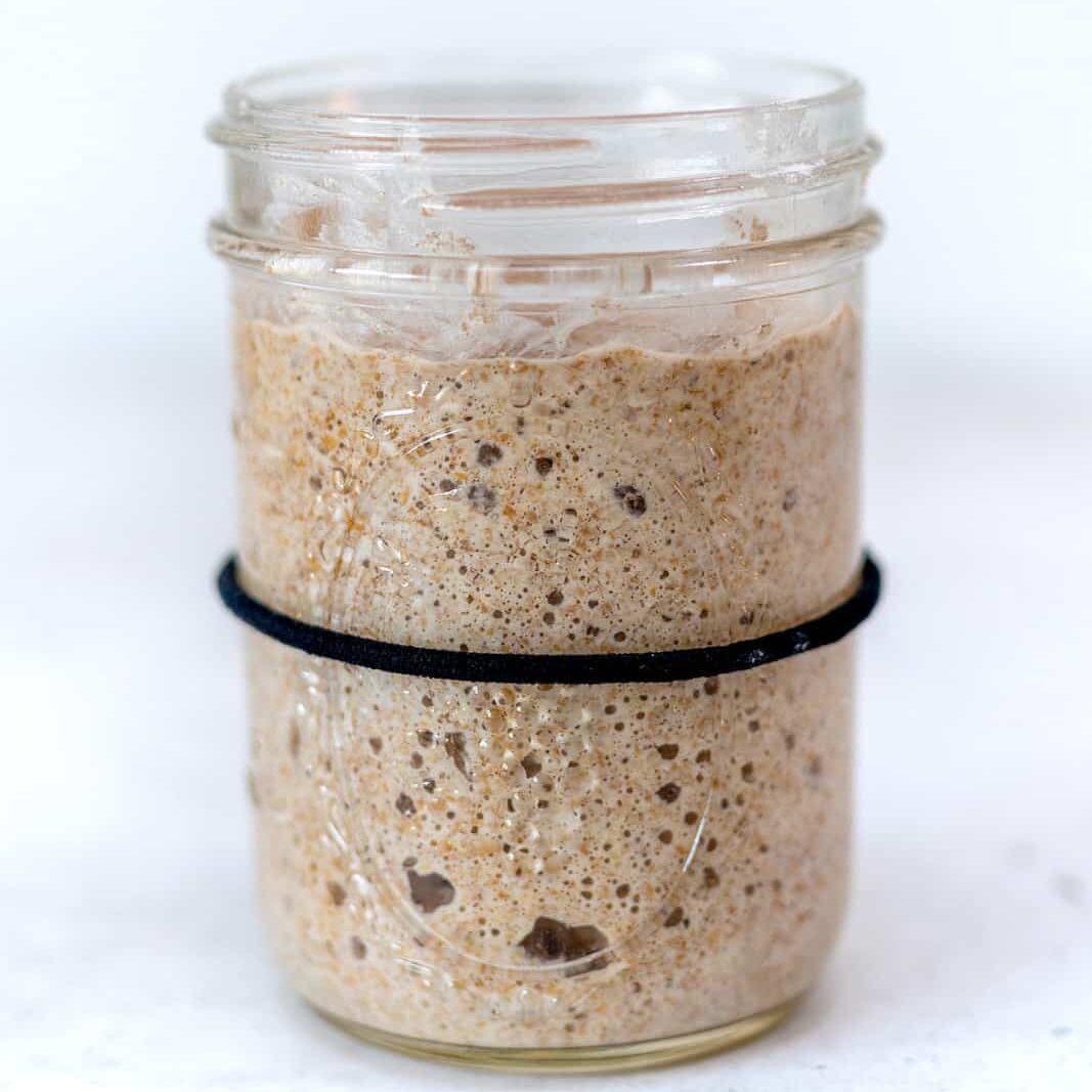 Bubbly sourdough starter in a glass jar