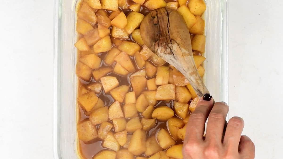 Spreading stewed apples in a glass Pyrex dish