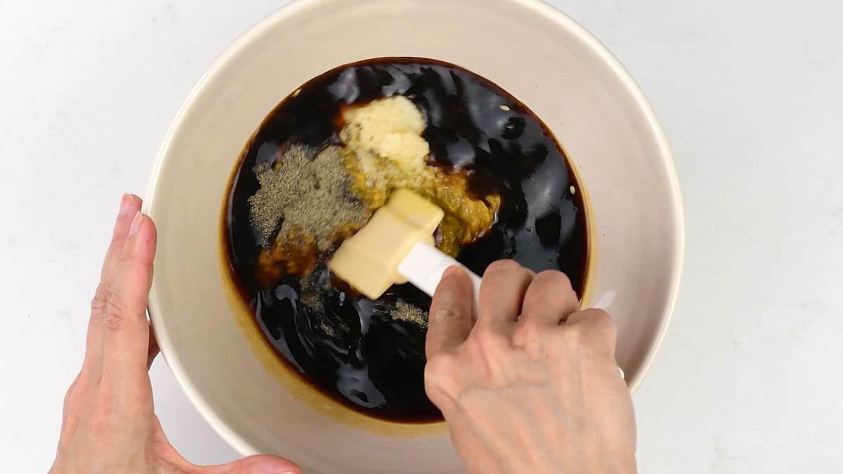 mixing ingredients for barbecue sauce in a bowl