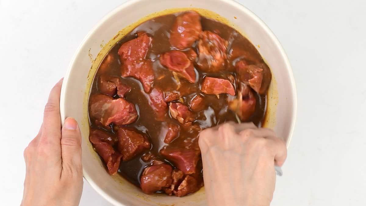 marinating lamb in Filipino barbecue sauce