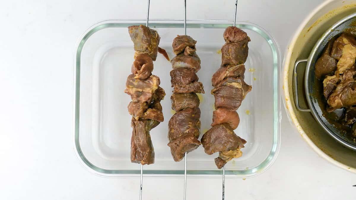 threading lamb onto metal skewers