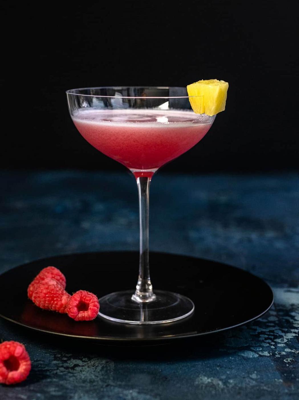 French Martini in a coupe glass garnished with pineapple wedge