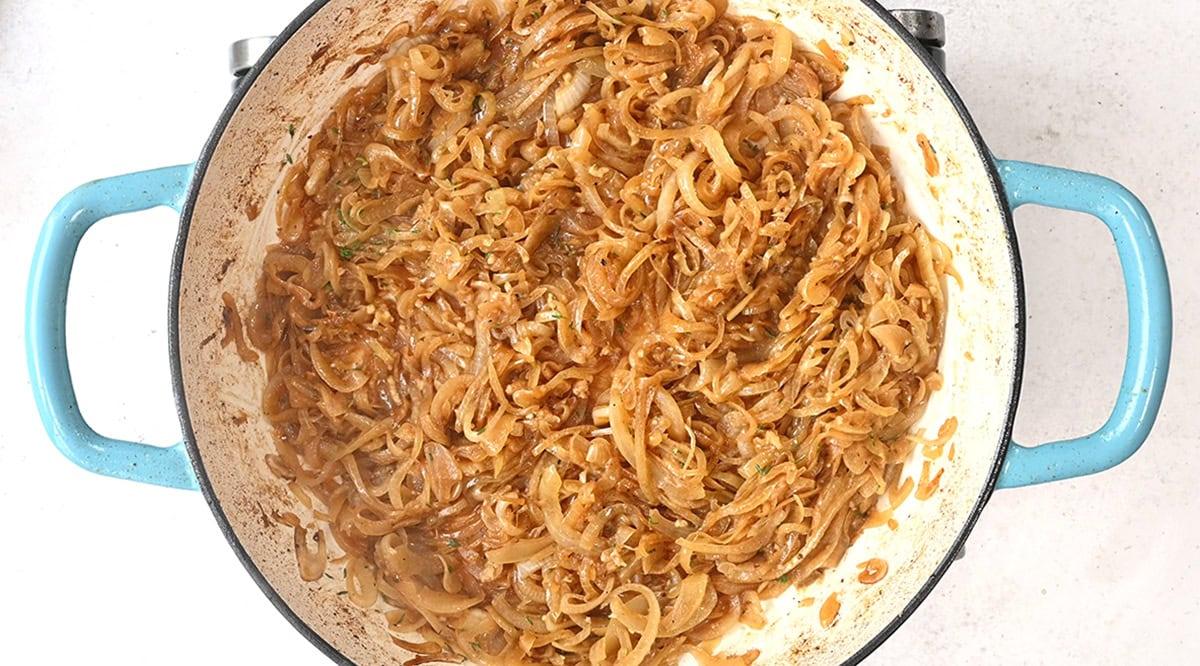 caramelizing sliced onions in a pan