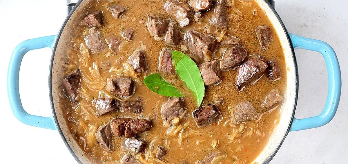 Beef stew in a casserole dish prior to cooking in the oven