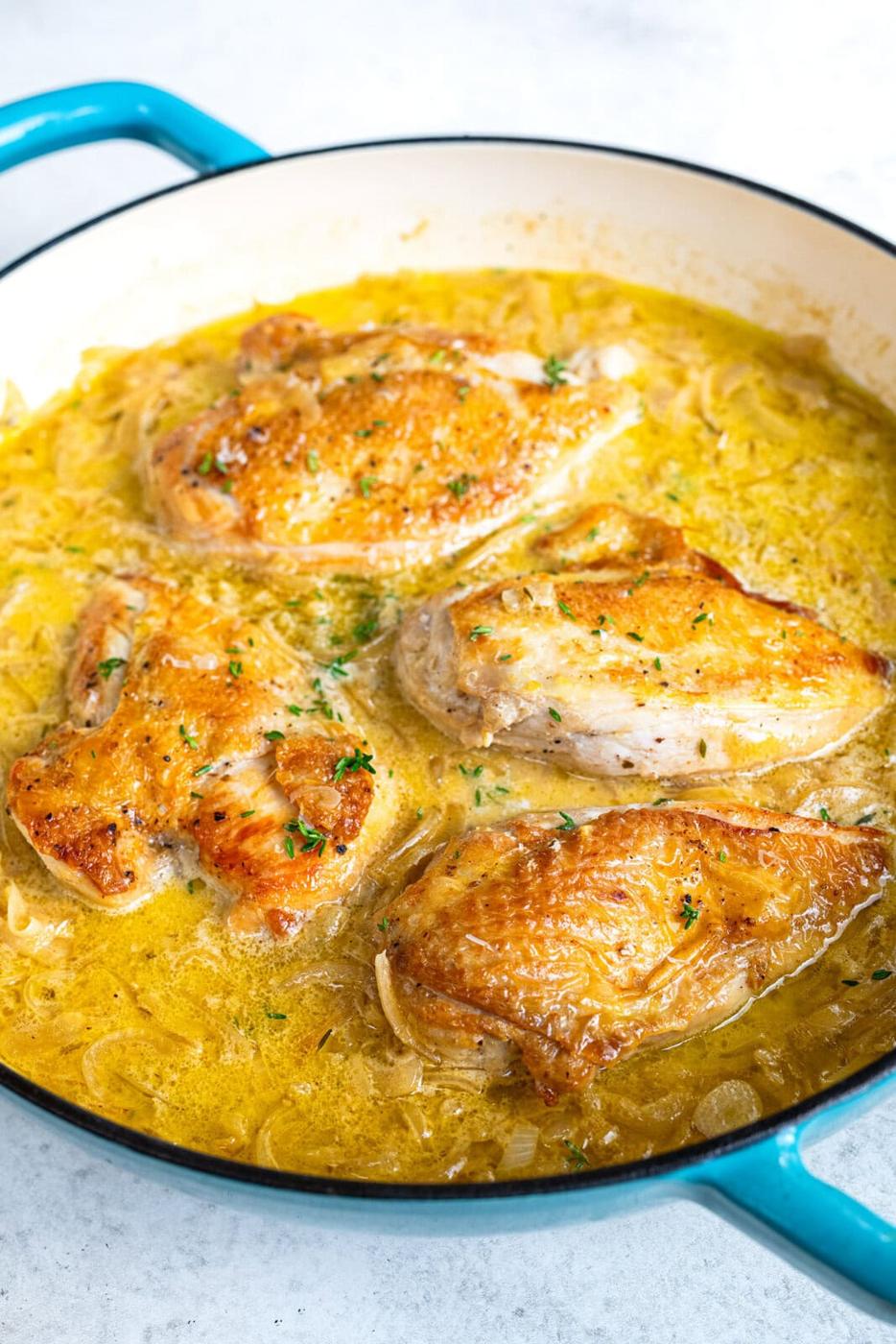 skillet with chicken breasts in french onion gravy