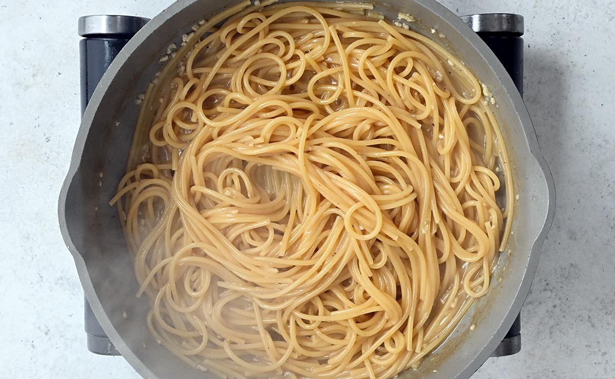 spaghetti cooking in a pan