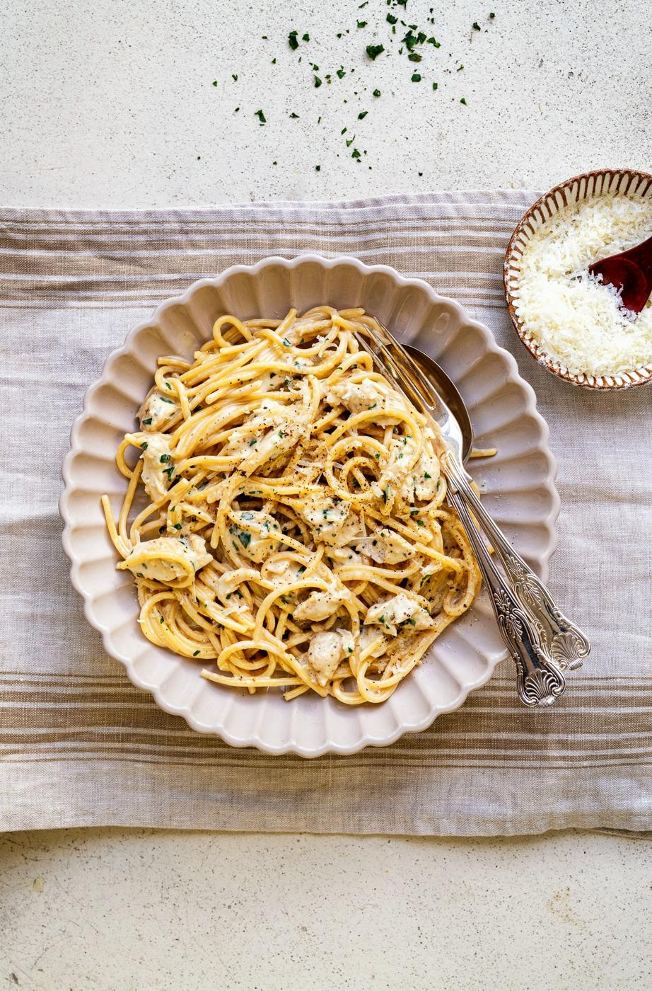 bowl serving of creamy chicken pasta with garlic and parmesan