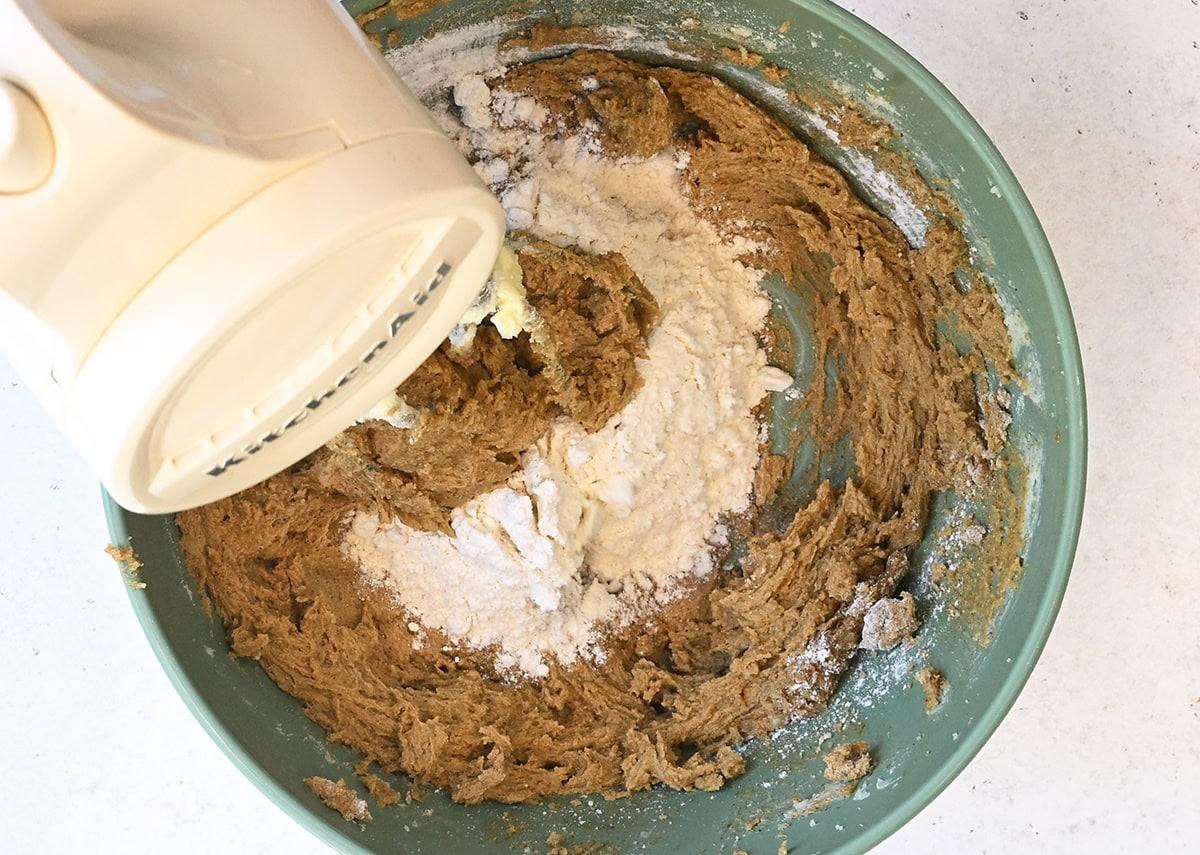 making ginger cookie dough using a hand mixer
