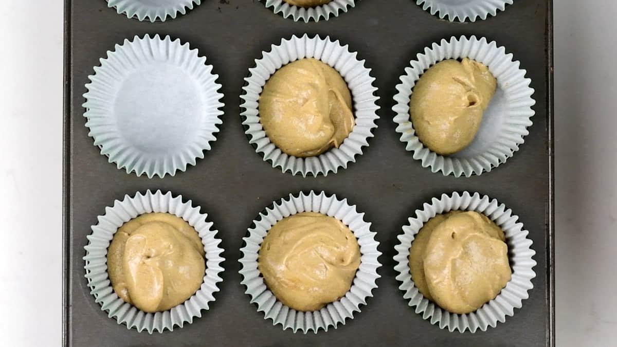 Gingerbread batter in cupcake cases ready for the oven