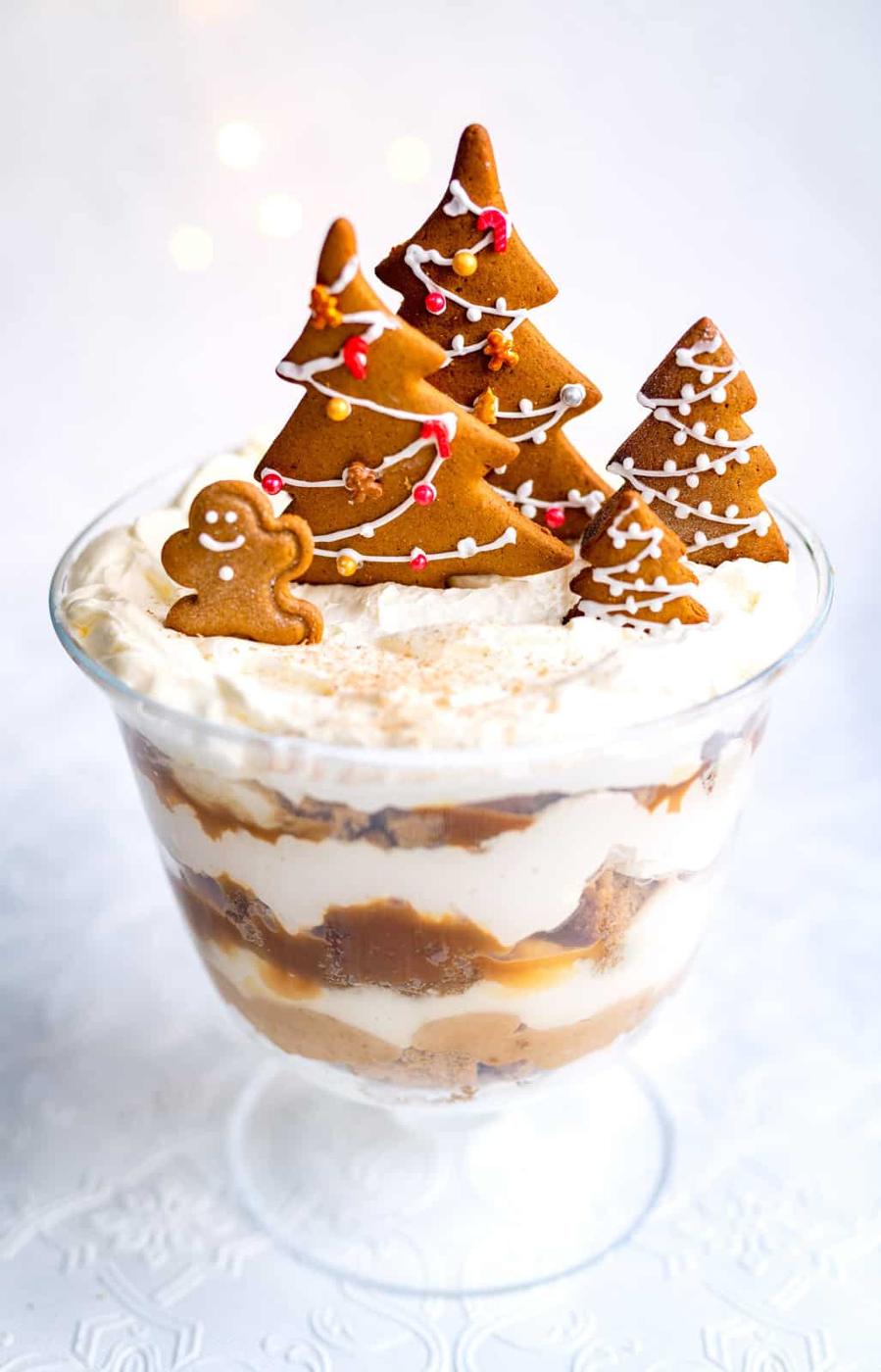 Gingerbread trifle in a glass bowl topped with cookies