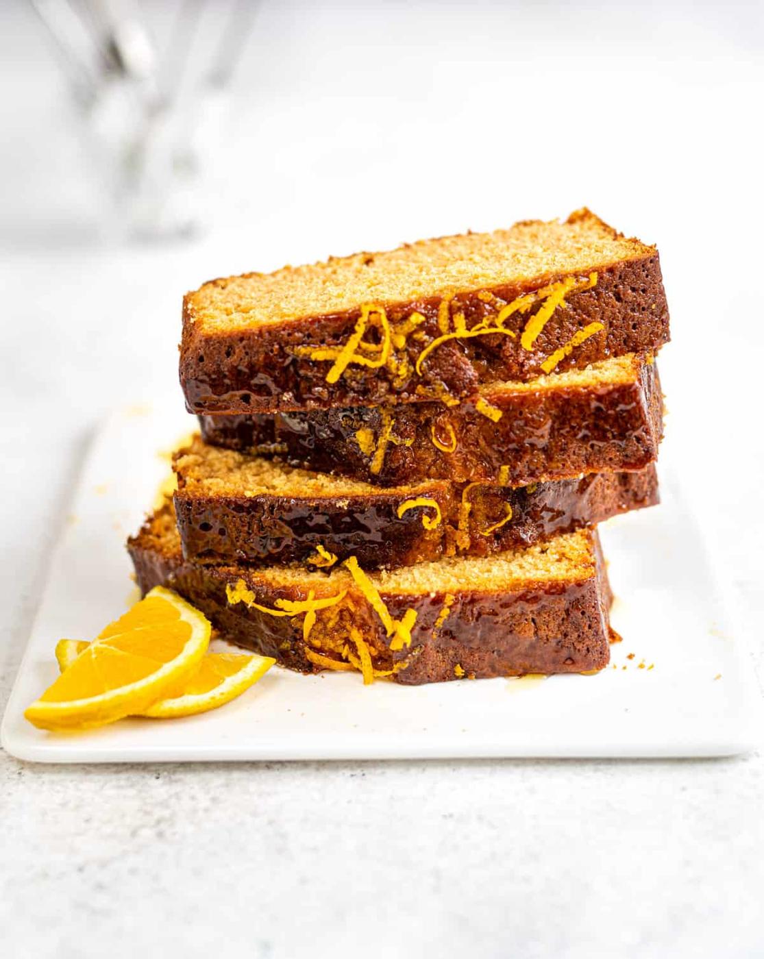 Golden syrup cake slices stacked on a ceramic board
