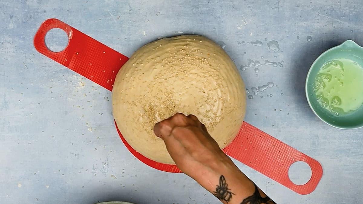 Sprinkling bread loaf with sesame seeds