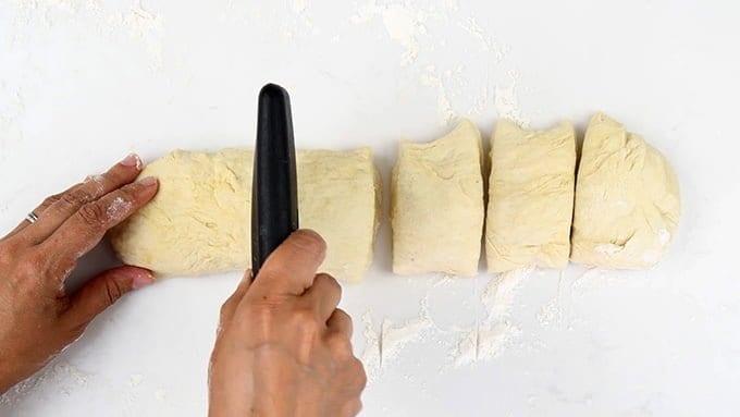 cutting pita dough into portions
