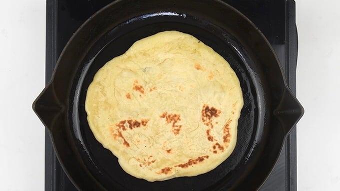 Pan frying homemade Greek pita bread