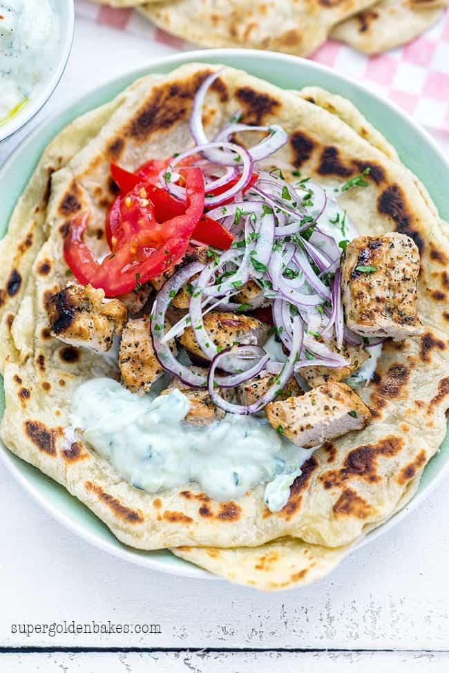 souvlaki pita - pork, tzatziki sauce, onions, tomatoes on a Greek pita bread