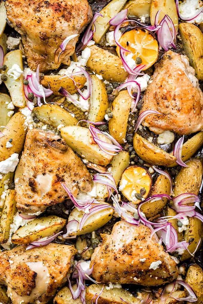 Greek sheet pan chicken with potatoes, capers and feta cheese – cooks in 30 minutes and simply packed with flavour! Serve with a crisp green salad and some crusty bread.