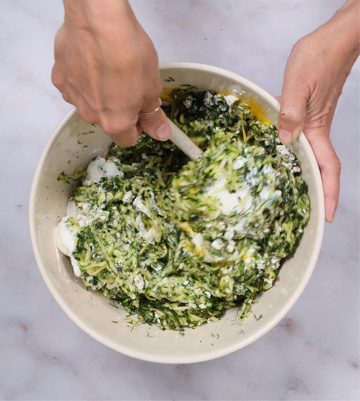 mixing the filling for Greek courgette pie