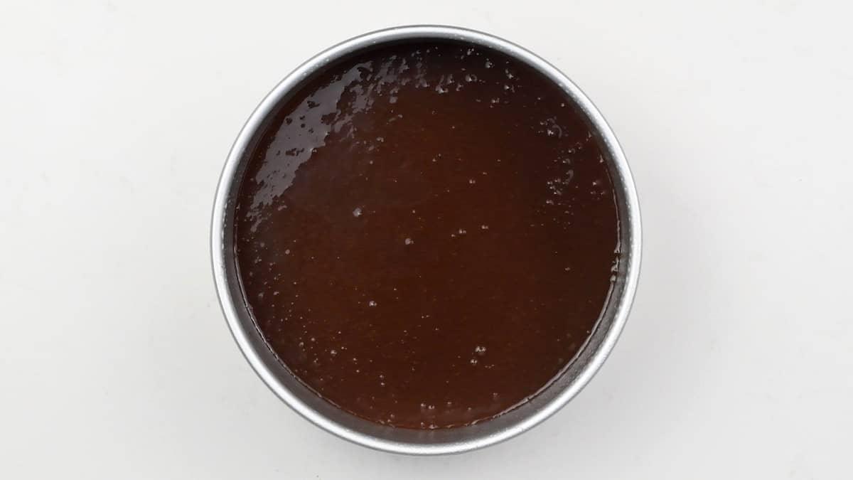 Chocolate cake batter in cake tin ready for the oven