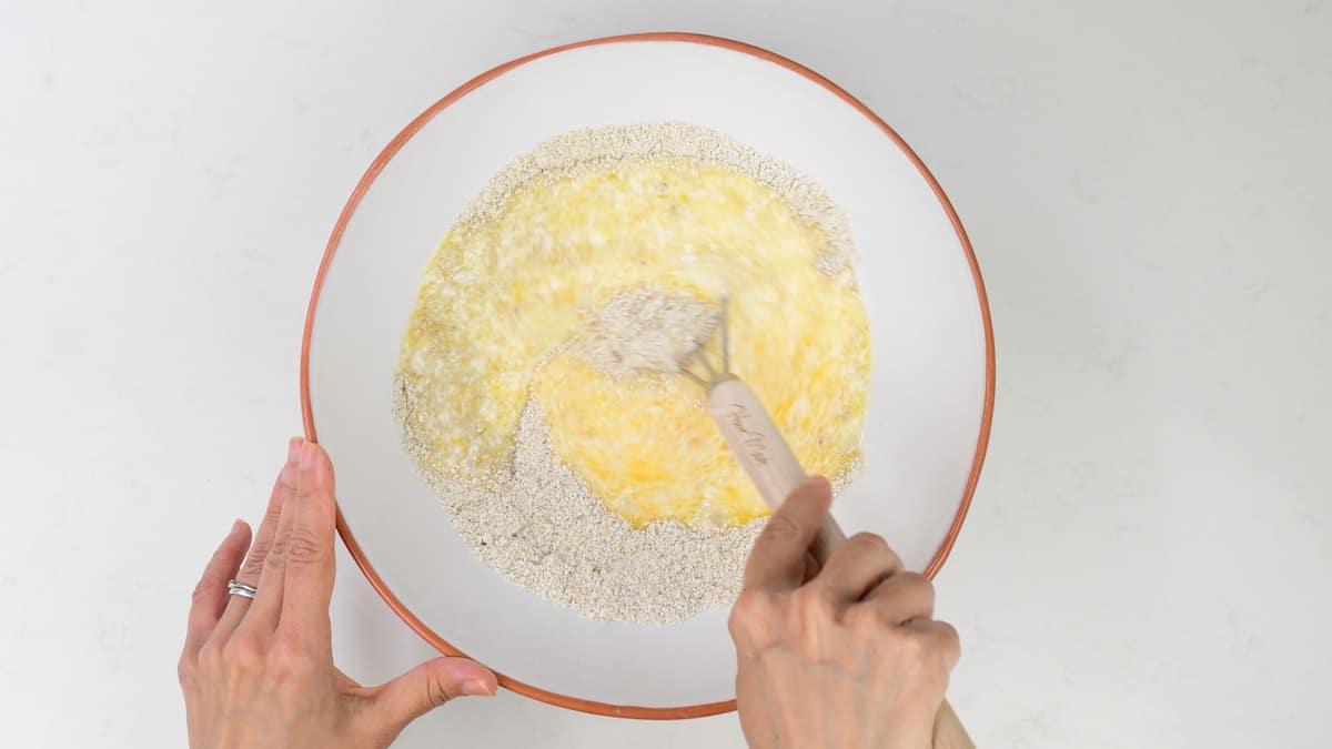 mixing batter for oat waffles in a bowl