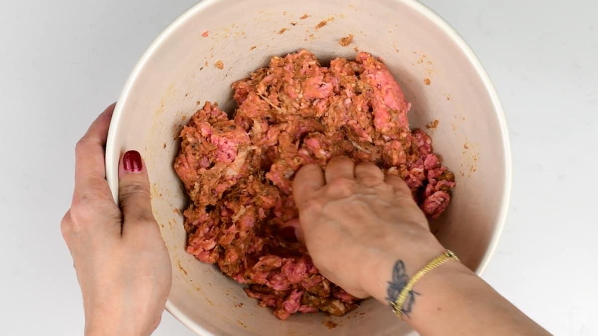 mixing lamb doner ingredients together in a bowl