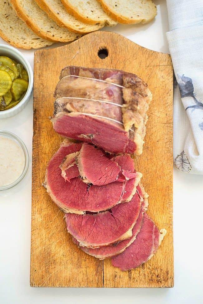homemade salt beef sliced on a wooden board