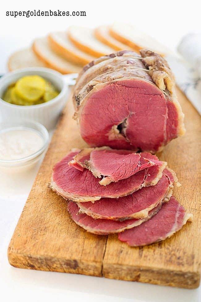 Sliced homemade salt beef on a wooden board