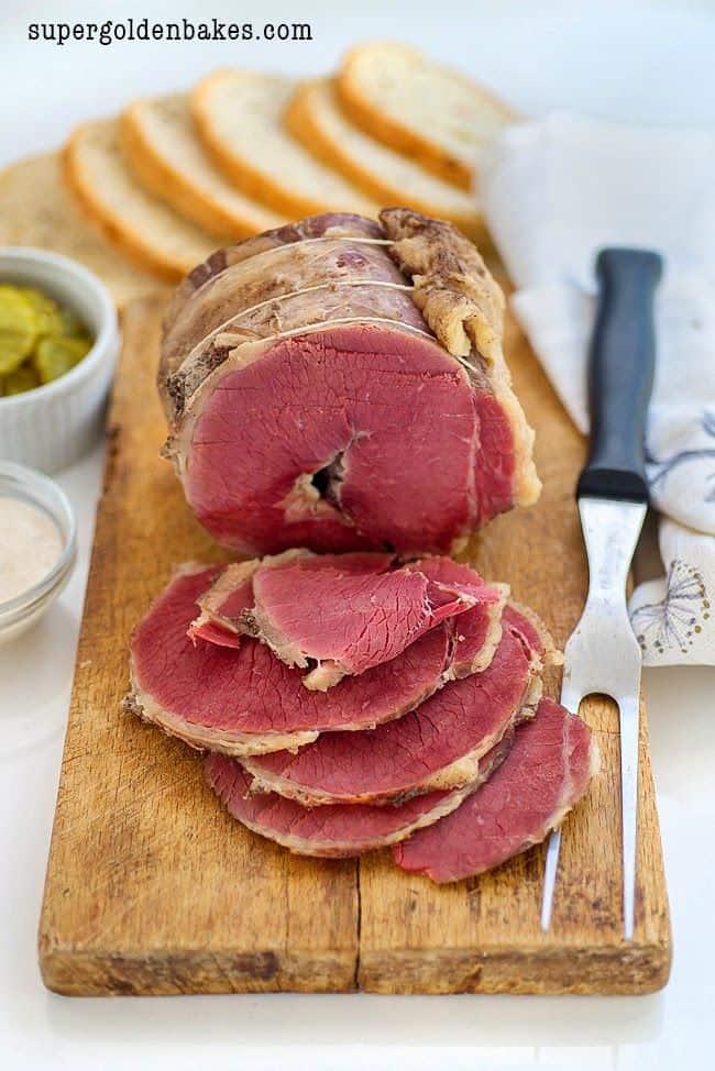 cured beef brisket sliced on a cutting board