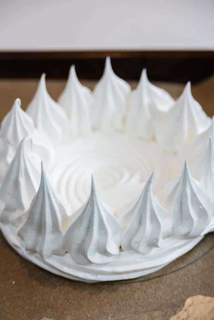 piping a meringue nest for pavlova