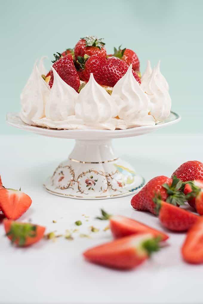 Pavlova crown with whipped cream, lemon curd and fresh strawberries