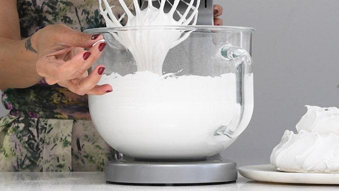 Checking sugar has dissolved in meringue