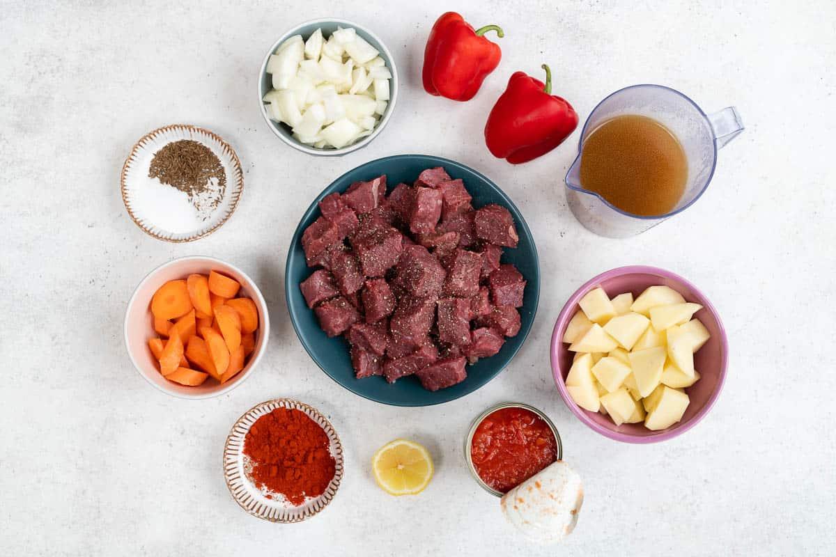 Ingredients for Hungarian goulash: diced beef, onions, garlic, carrots, potatoes, red peppers, paprika, caraway seeds and beef stock