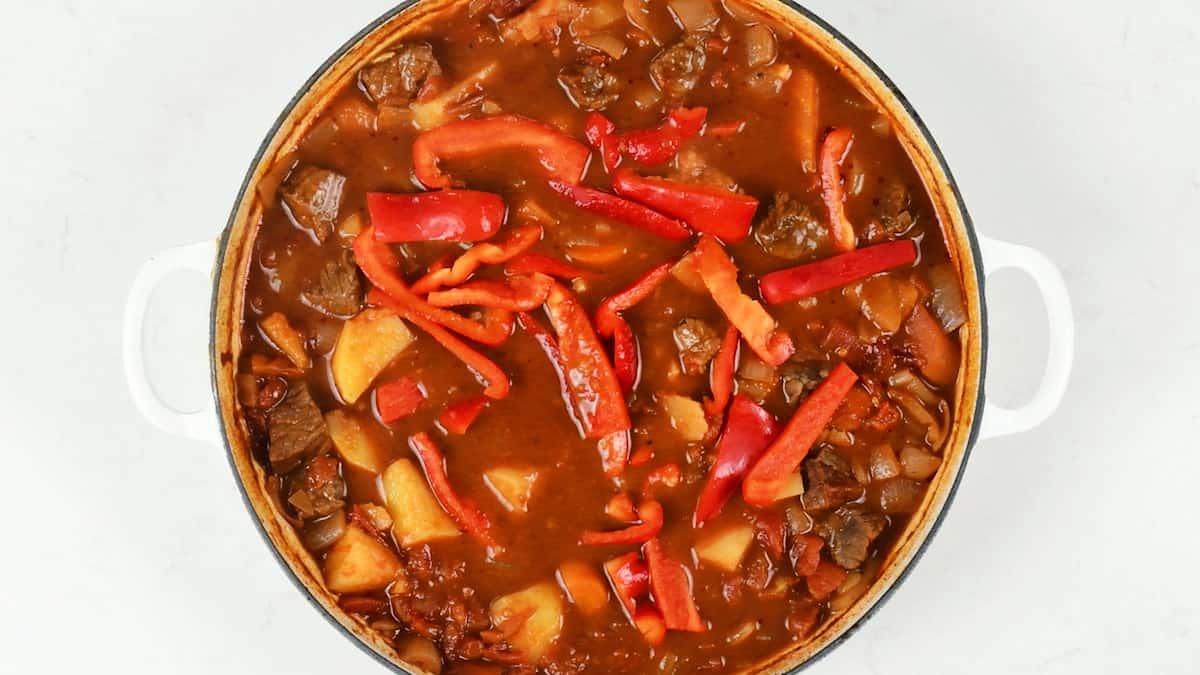 Sliced red peppers added to the goulash for the last 30 minutes