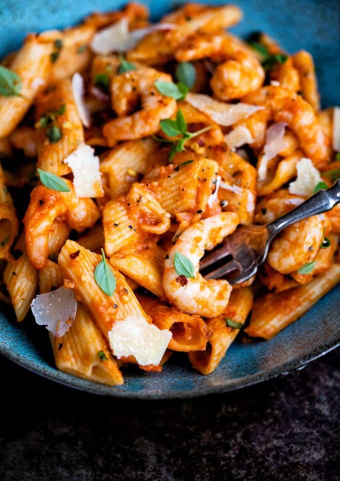 Close up on a bowl of penne arrabbiata with shrimp